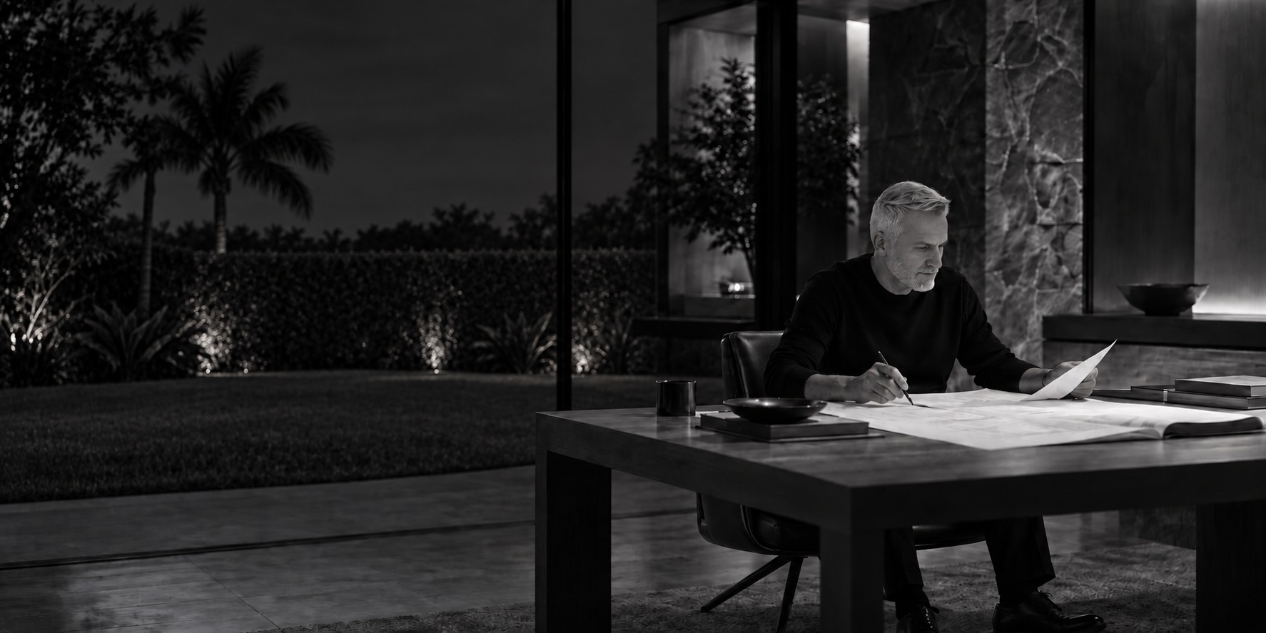 Carmelo reviewing residential plans in an architectural interior